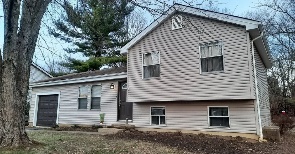 Residential exterior showcasing alside siding paired with energy efficient windows and a clean front door